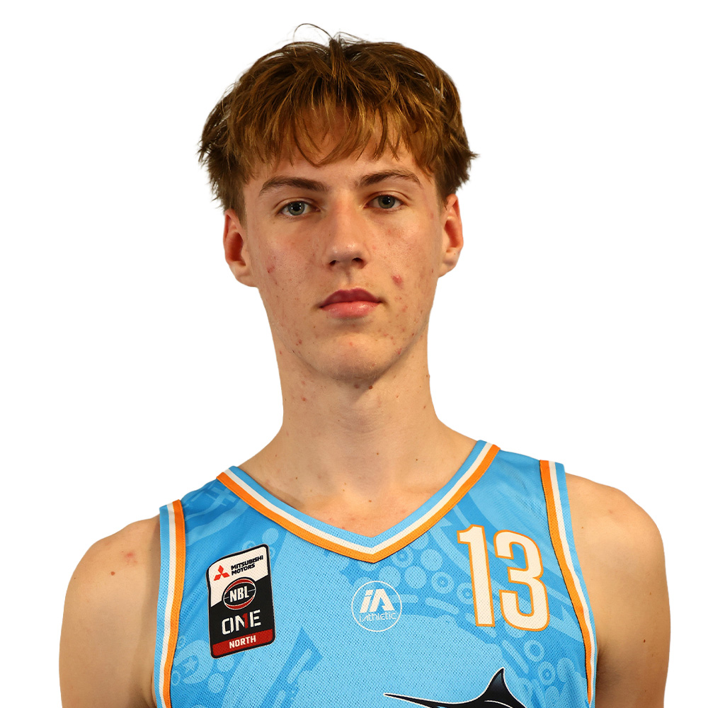 Portrait of a young male basketball player facing the camera, wearing a light blue jersey with the number 13 and patches on the chest.