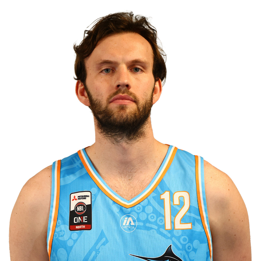 Portrait of a man with a beard wearing a light-blue basketball jersey with the number 12, facing the camera.