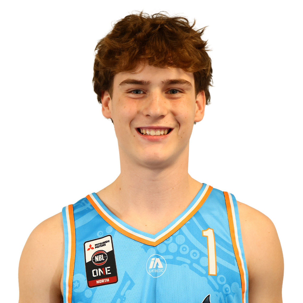 Young man smiling in a light blue basketball jersey with the number 1, facing camera.