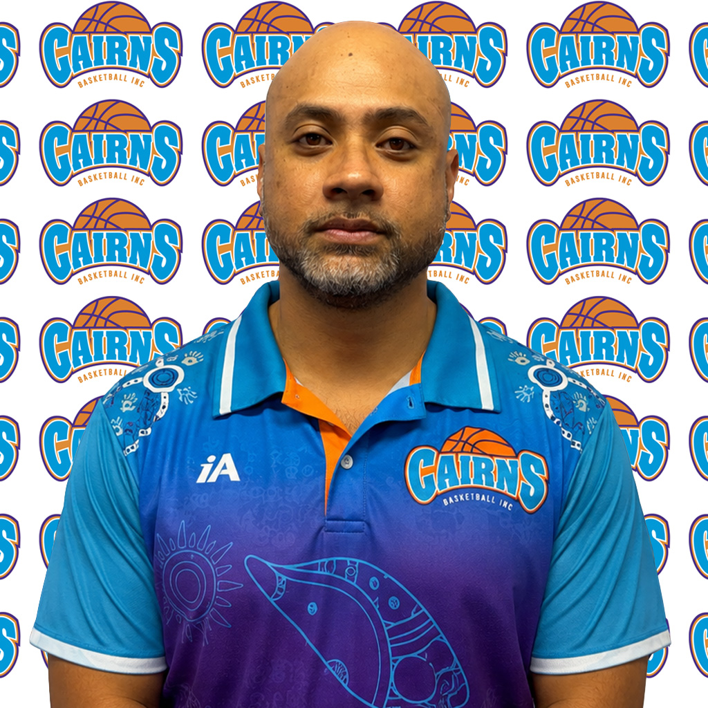 Portrait of a man in a Cairns Basketball Inc jersey, standing before a repeating Cairns backdrop logo.
