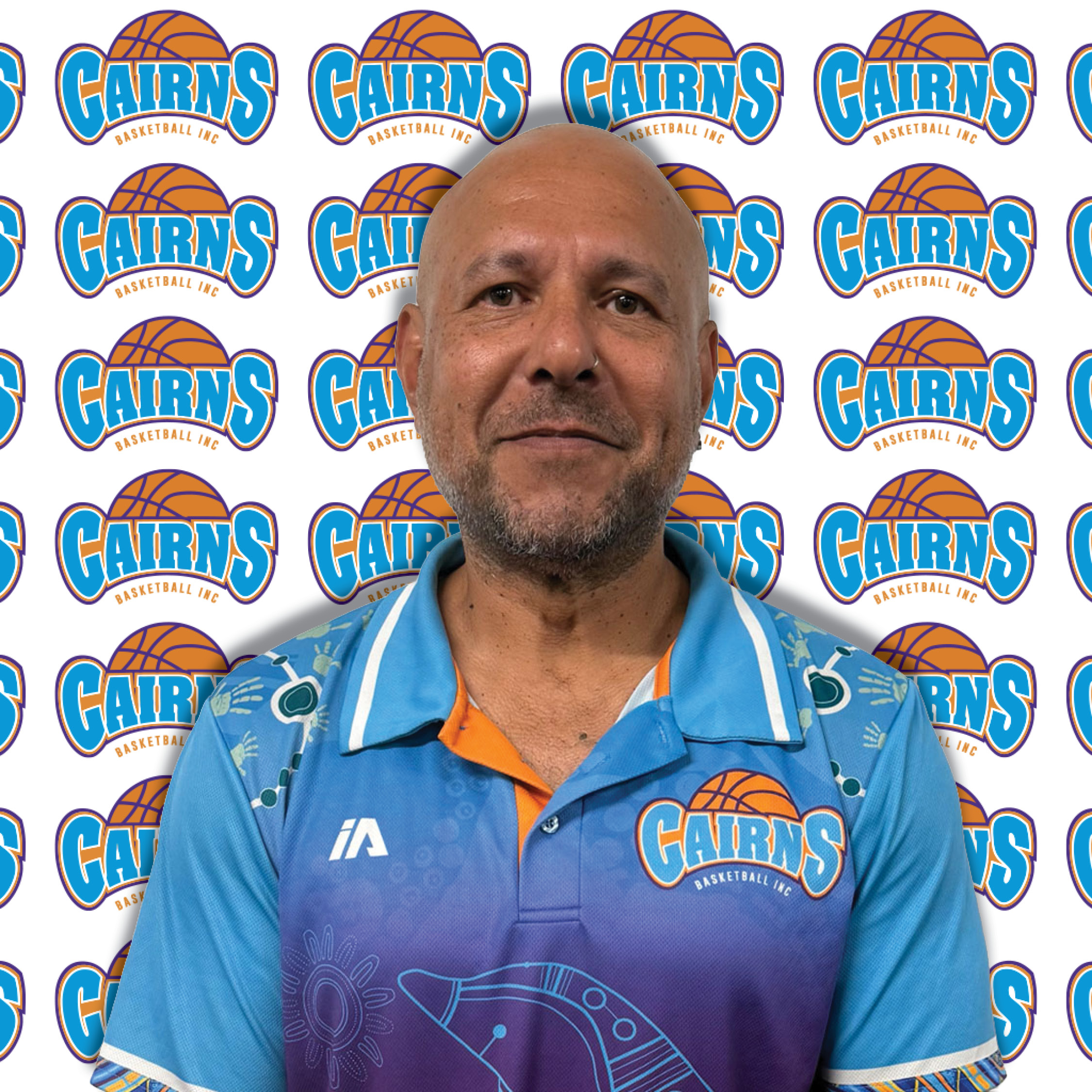 Man's face centered against a repeating Cairns Basketball logo backdrop.