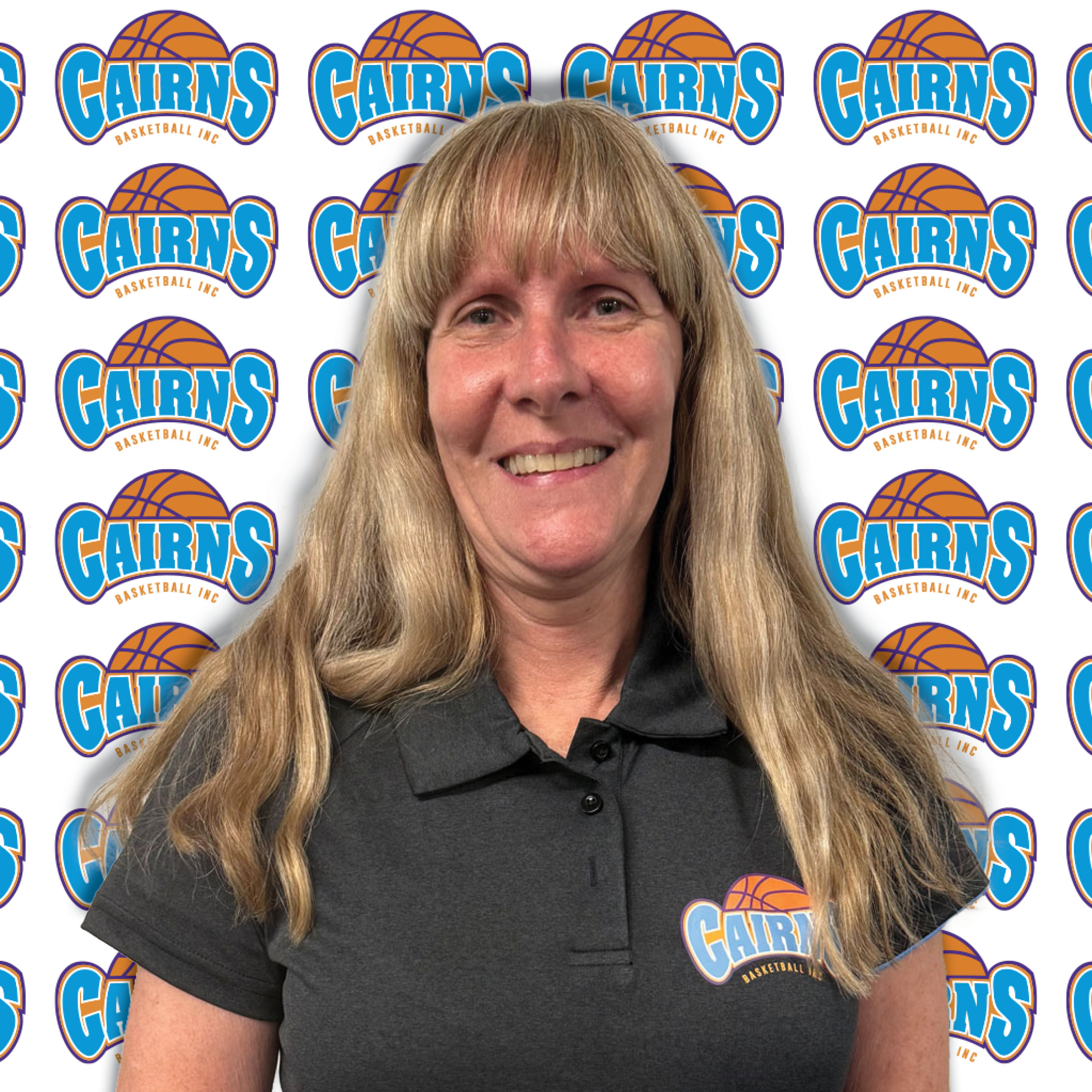Smiling woman photographed against a repeating Cairns Basketball backdrop backdrop.