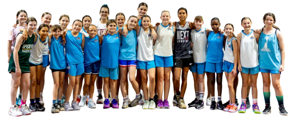Group of smiling young basketball players wearing blue and white uniforms posing together for a team photo.